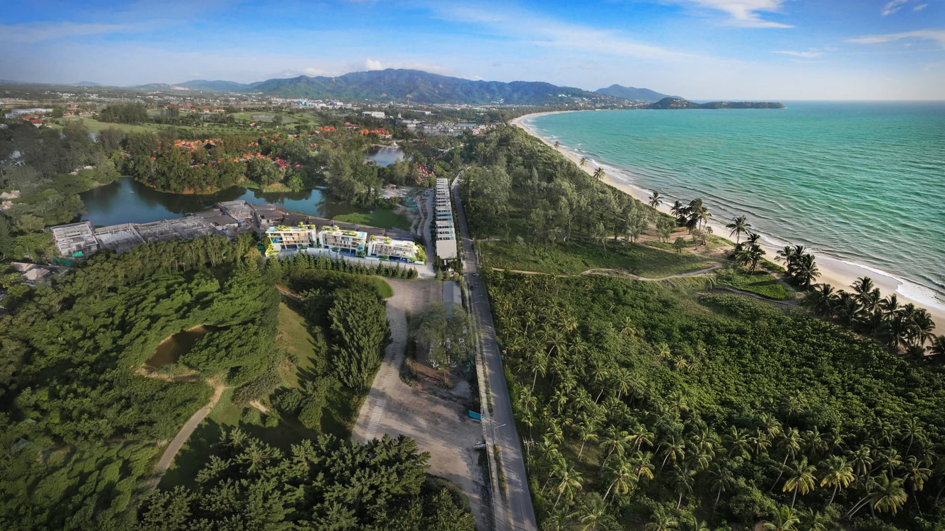 Bang Tao from the air: the three Nerea buildings beside the lagoon, the casuarina strip and the beach curving south